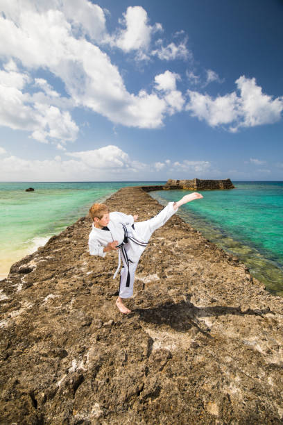 istock Young Karate black belt kicking 944439560
