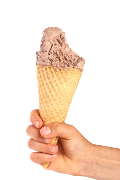 istock bitten chocolate ice cream in a waffle horn in the hand isolated on a white background 944439764