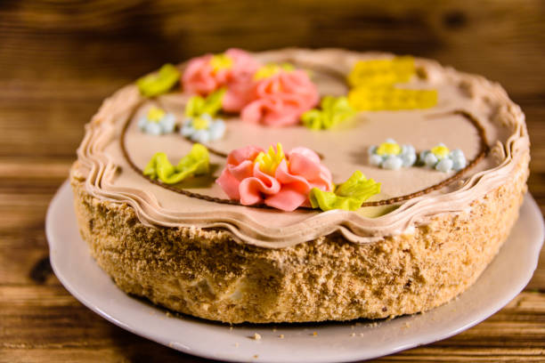 istock Kiev cake with cream on wooden table 944447336
