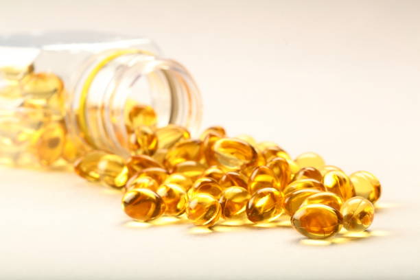 istock Healthy sea cod fish oil capsules on white background. 944447360