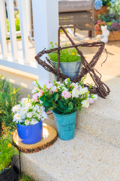 istock An artificial flowers in blue pot on floor in a porch. 944448906