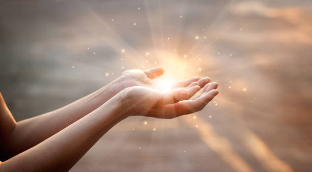 istock Woman hands praying for blessing from god on sunset background 944453618