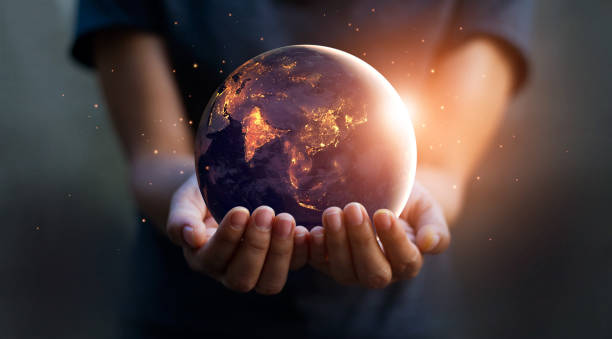 earth at night was holding in human hands. earth day. energy saving concept, elements of this image furnished by nasa - planeta terra imagens e fotografias de stock