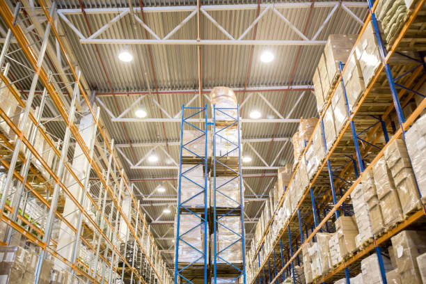 istock Tall warehouse shelving racks filled with goods 944457286