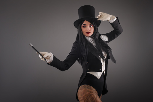 Female Magician In Costume Suit With Magic Stick Doing Trick Stock Photo -  Download Image Now - iStock