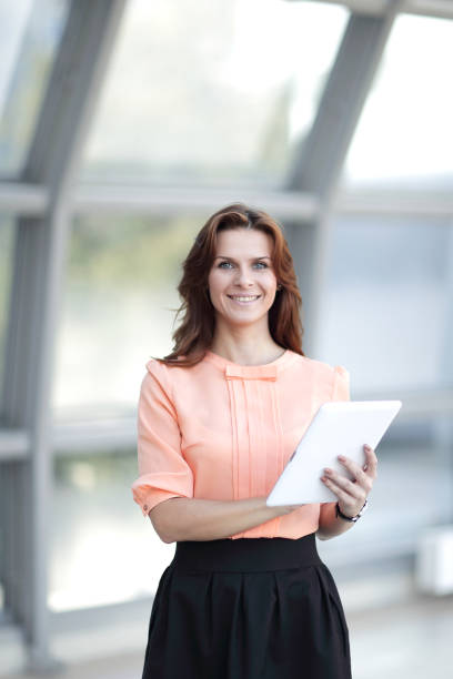 istock modern woman with digital tablet standing in office 944467866