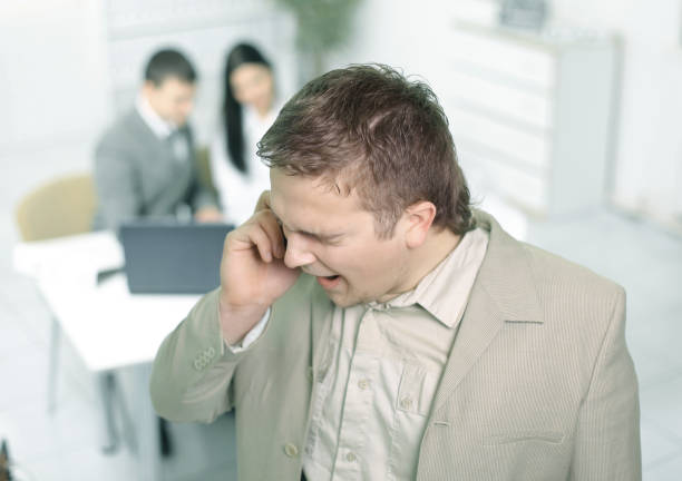istock closeup.Manager talking on mobile phone in office 944468064