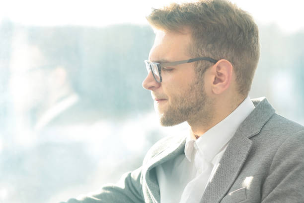 istock close up.pensive businessman with e-cigarette sitting in the break room 944468414
