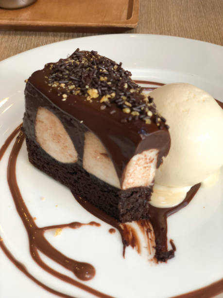 istock Delicious chocolate cake with vanilla ice cream on white dish 944468716