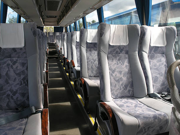 Empty bus passenger seats with seatbelt and head cloth