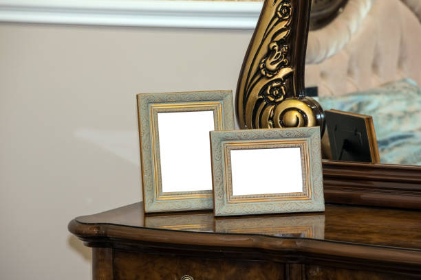 Chest of drawers with two blank photo frames Two blank photo frame on the chest of drawers. Mock up of blank photo frames chest torso photos stock pictures, royalty-free photos & images