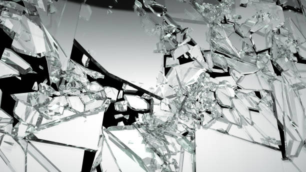 istock Broken shattered glass pieces isolated on black 944478014