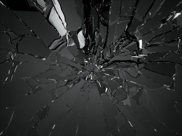 istock Broken shattered glass pieces isolated on black 944478168