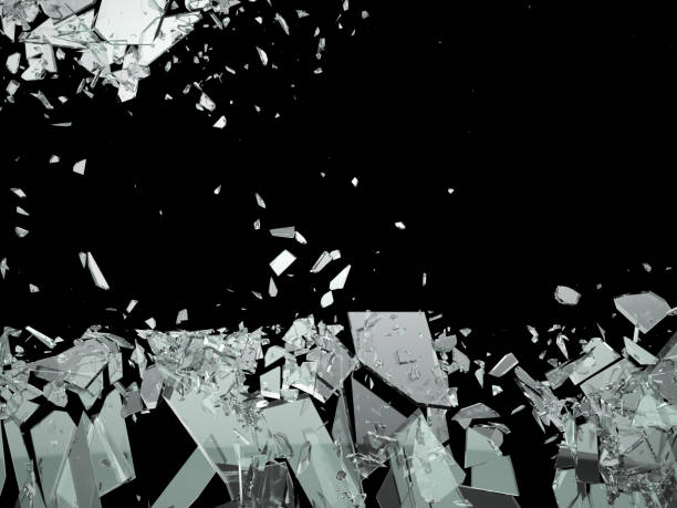 istock Broken shattered glass pieces isolated on black 944478216