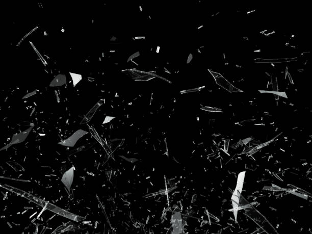 istock Broken shattered glass pieces isolated on black 944478228