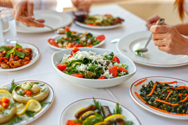 Couple  Eating Lunch with Fresh Salad and Appetizers Couple  Eating Lunch with Fresh Salad and Appetizers Artichoke stock pictures, royalty-free photos & images