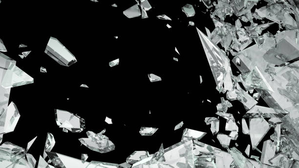 istock Broken shattered glass pieces isolated on black 944478344