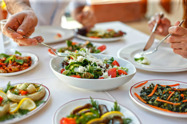 istock Couple  Eating Lunch with Fresh Salad and Appetizers 944478478