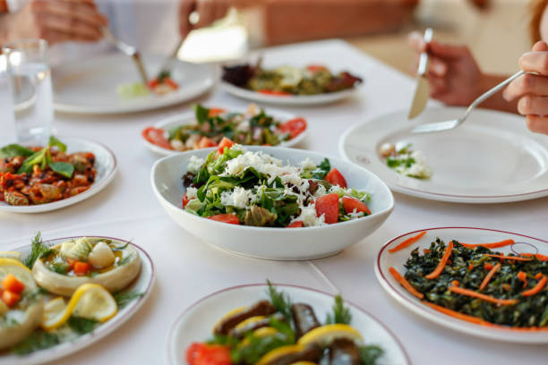 istock Couple  Eating Lunch with Fresh Salad and Appetizers 944478512