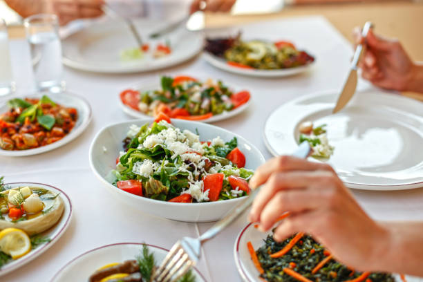 istock Couple  Eating Lunch with Fresh Salad and Appetizers 944478570