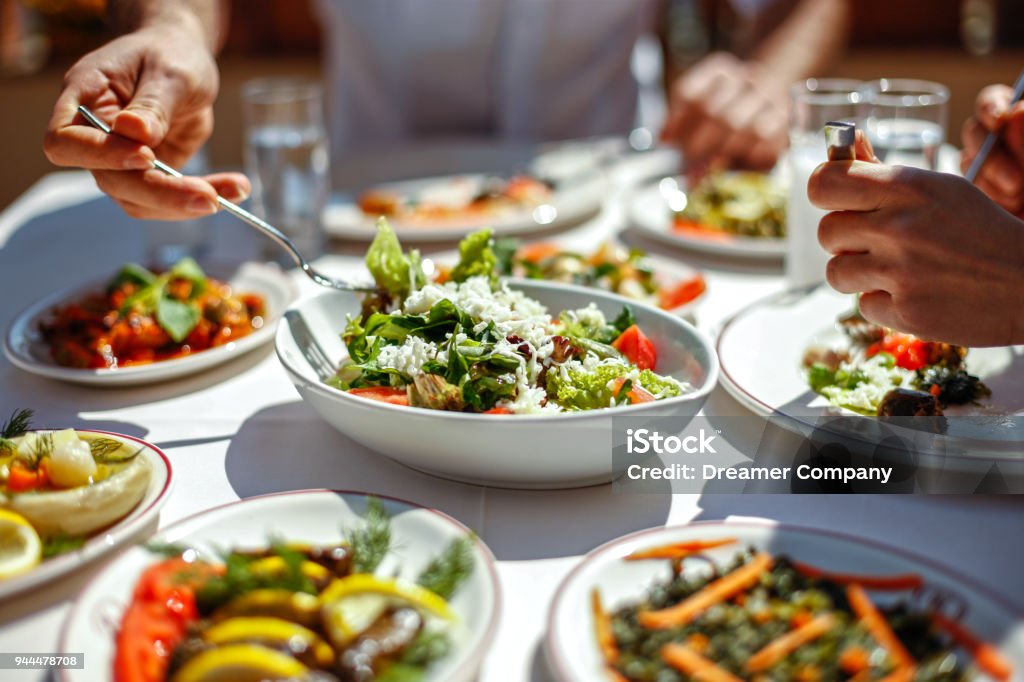 Couple  Eating Lunch with Fresh Salad and Appetizers Food Stock Photo