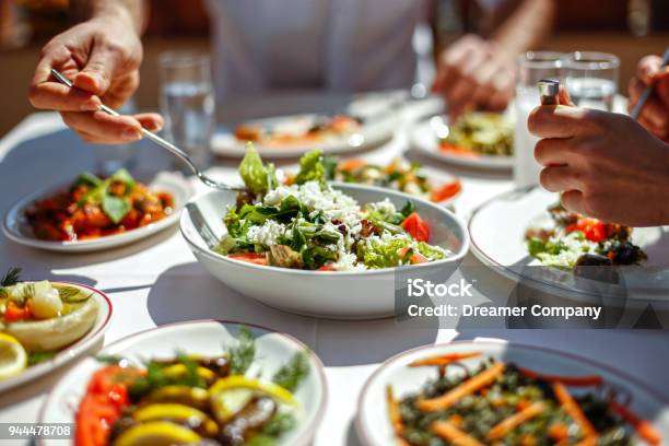 Couple Eating Lunch With Fresh Salad And Appetizers Stock Photo - Download Image Now
