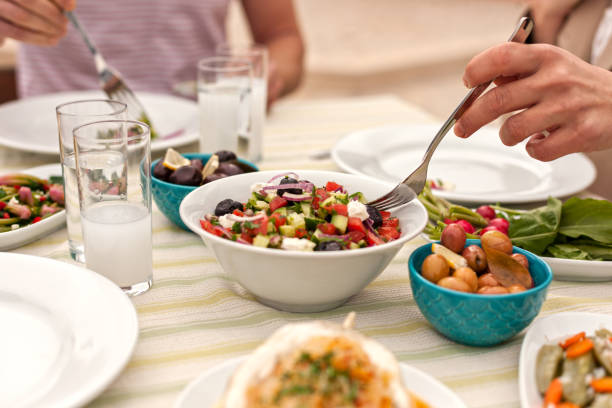 istock Couple  Eating Lunch with Fresh Salad and Appetizers 944478758