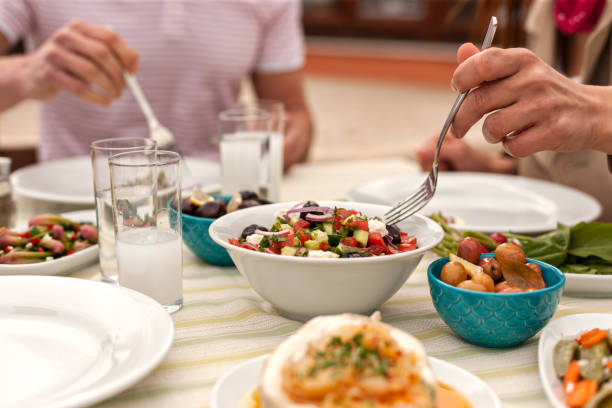istock Couple  Eating Lunch with Fresh Salad and Appetizers 944478800