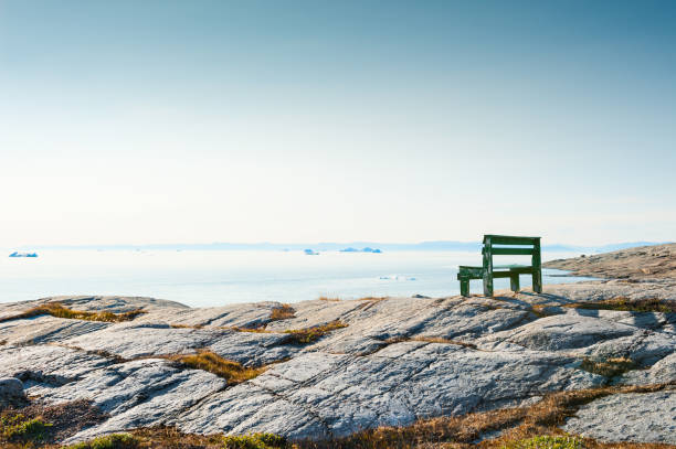 istock Lonely bench on the rocky coast in Greenland 944478816
