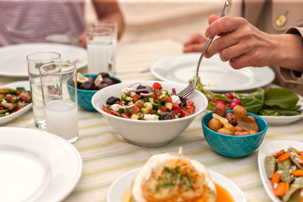 istock Couple  Eating Lunch with Fresh Salad and Appetizers 944478846