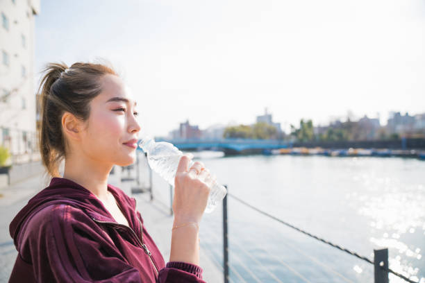 istock Young woman drinking water 944482946