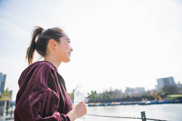 istock Young woman drinking water 944482962
