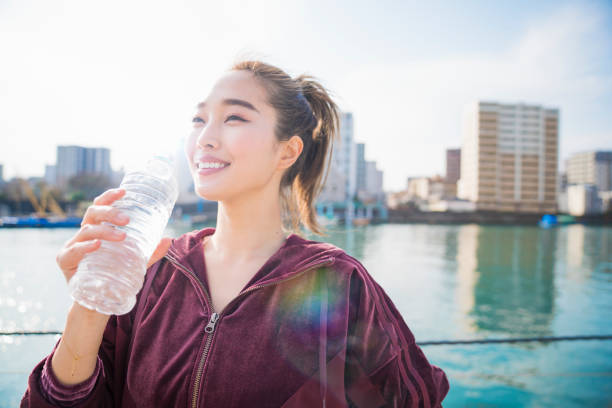 istock Young woman drinking water 944482970