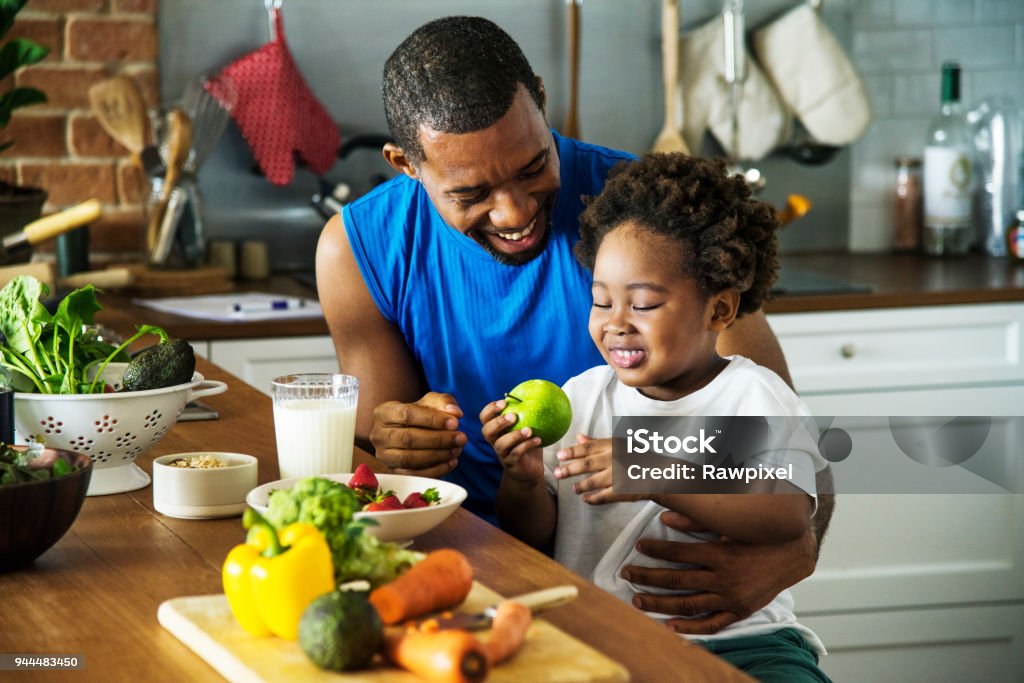 Papà e figlio cucinano insieme - Foto stock royalty-free di Alimentazione sana