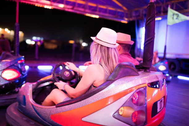 istock Couple riding bumper cars 944486536
