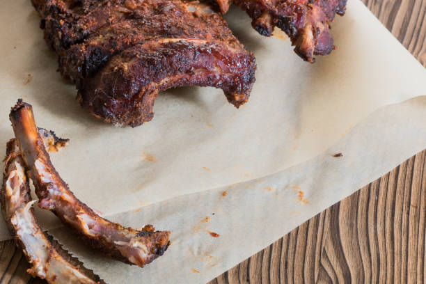 istock Grilled Spareribs with gnawed bones on backed paper - Copy Space 944486756