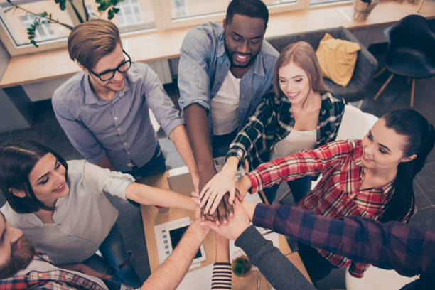 istock Creative multinational business team putting hands together at the office 944490718