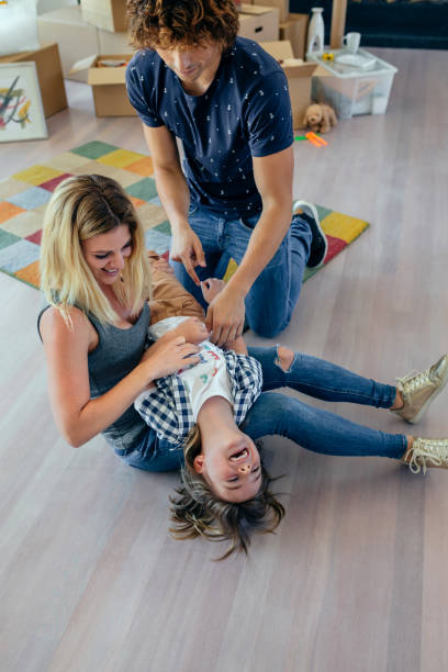 istock Parents tickling their son 944490732