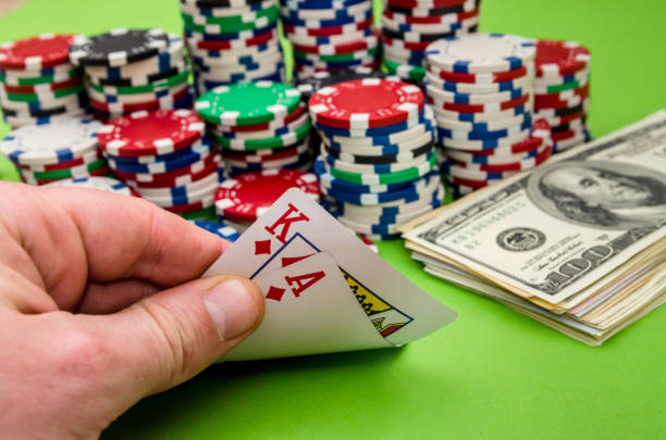 istock Playing card combination in man's hand, on green background 944493332