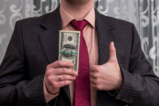istock Businessman with dollar banknotes in one hand and thumb up 944493456