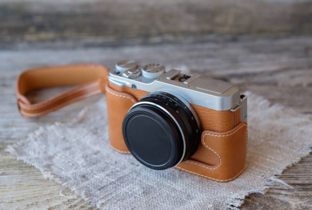 istock mirrorless camera in vintage style on wooden table 944497376