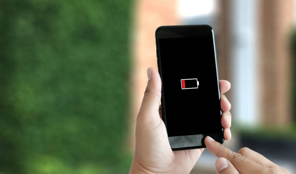 istock Close up man hands using smart phone battery low charged battery screen 944500688