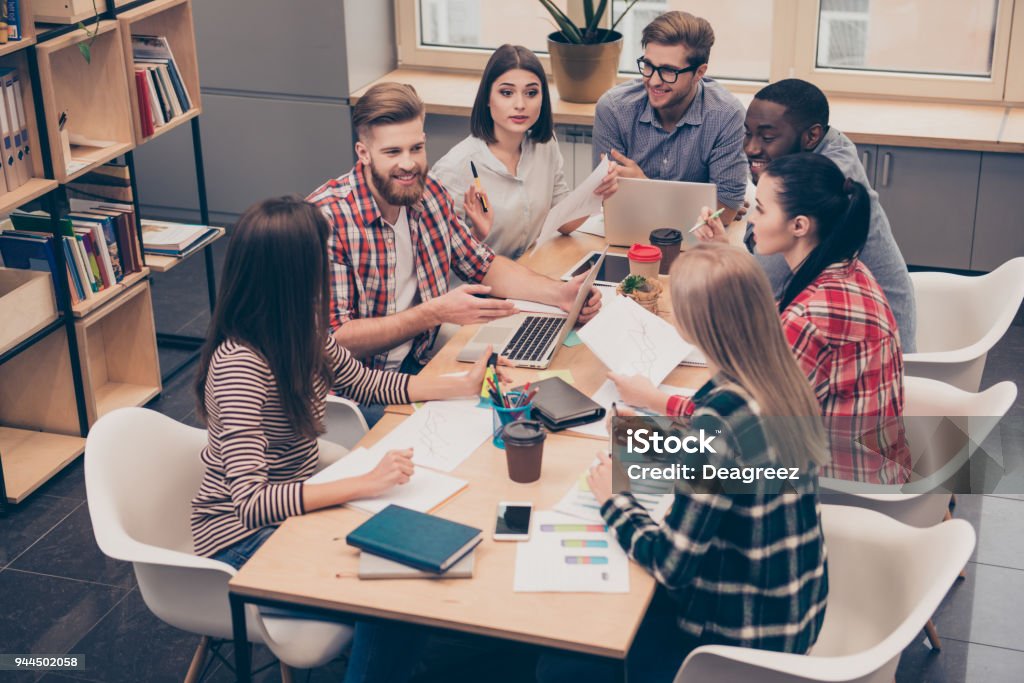 multinational businesspeople having relaxed conversation over new project Partnership - Teamwork Stock Photo