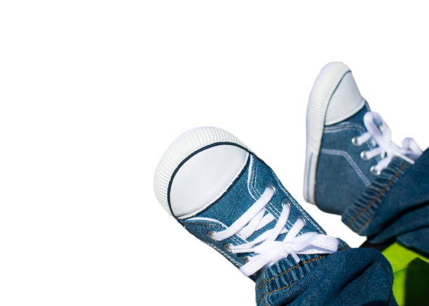 istock Close-up on child feet with sneakers 944502612