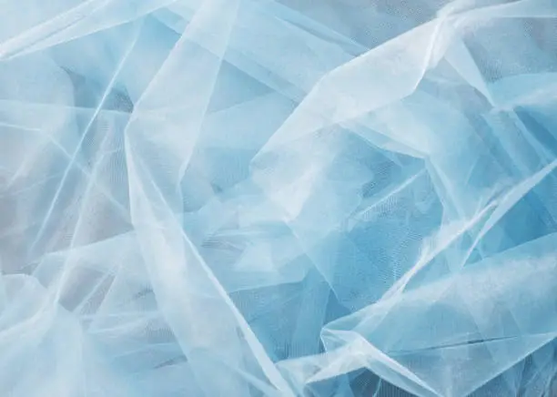 A background texture of sky blue tulle