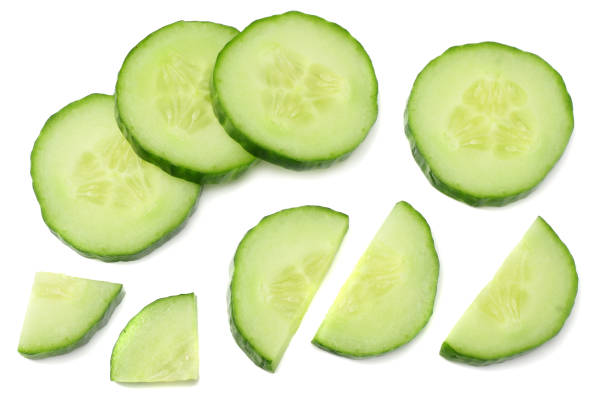 istock fresh cucumber slices isolated on white background. top view 944506110