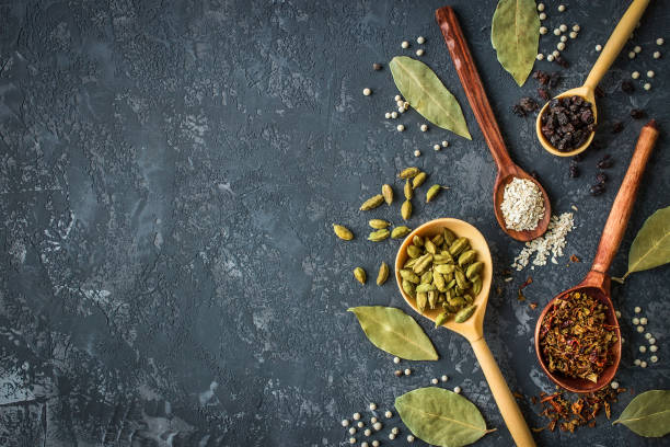 istock spices and herbs over black stone background