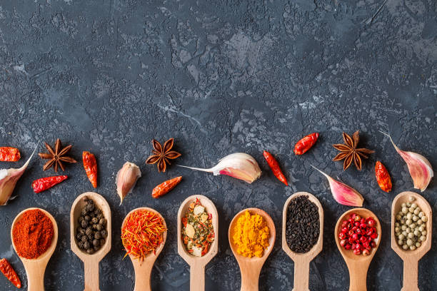 istock Various spices in wooden spoons  on dark  table. 944506322