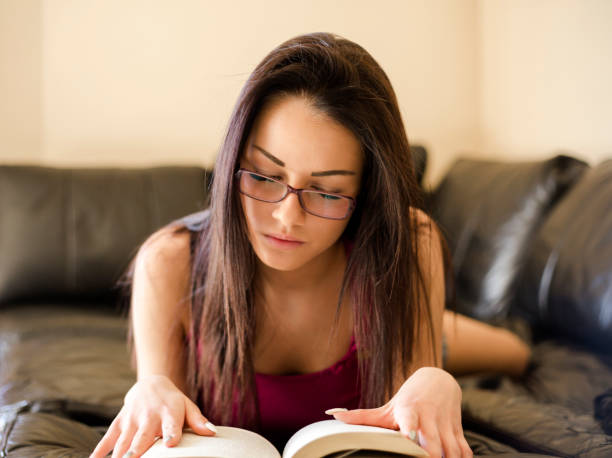 istock Young woman reading at home 944506388