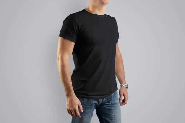 istock Mockup  black cotton T-shirt on a young guy posing on a gray background. 944507058